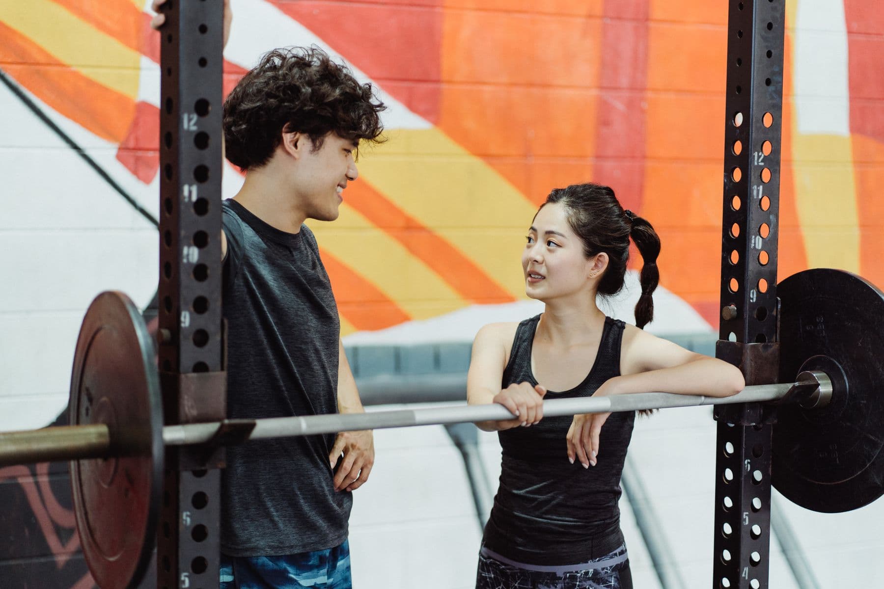 Three people connecting after training in a gym